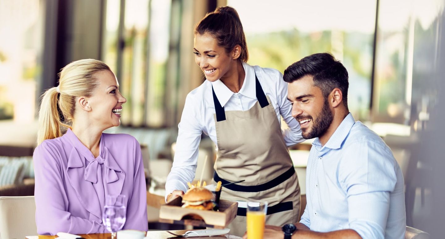 Waitress serving diners