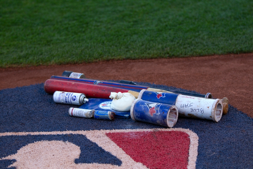 A Major League Baseball on-deck circle with a row of bat weights for players to warm up.