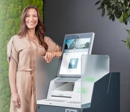 Woman next to the new KePlus D10 service terminal