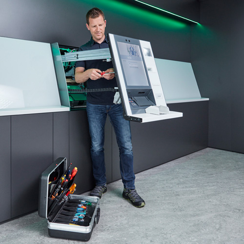 A service technician works on a ATM of the evo eries.
