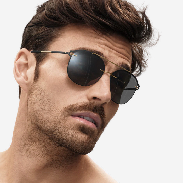 Male model wearing Accent Shades 8730, frame colour 9030 Black / Gold, lens colour SLM POL Grey