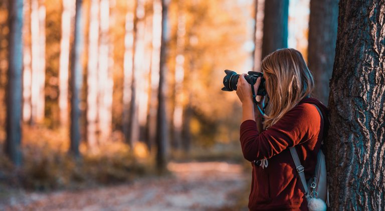 girl taking a photo in the nature