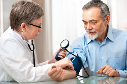 doctor measuring blood pressure of male patient