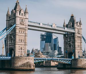 A combined bascule and suspension bridge spanning a river with two tall and elaborate stone towers