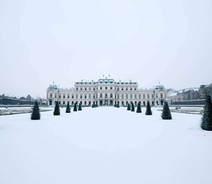 A snow-covered plaza leading up to a palace