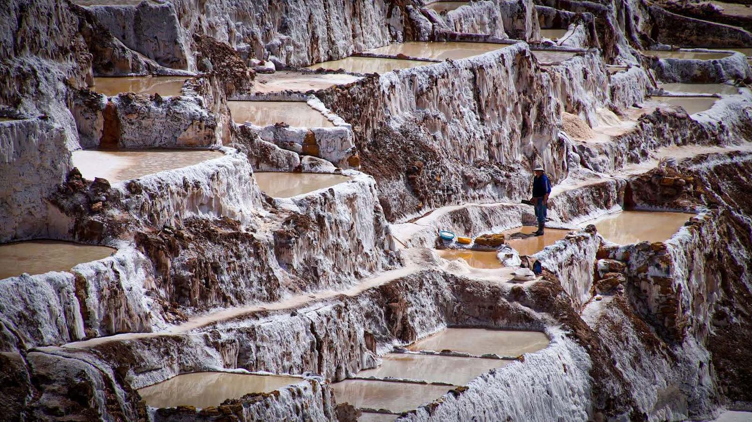 Mountainside ridges with pools of water.