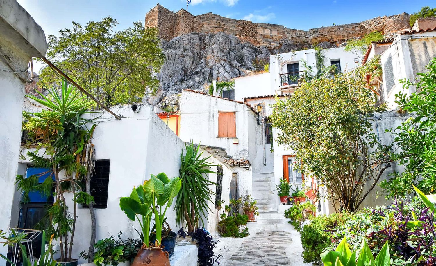 Narrow walkways and staircases of Anatiofika, a quaint colorful village in Athens, Greece.