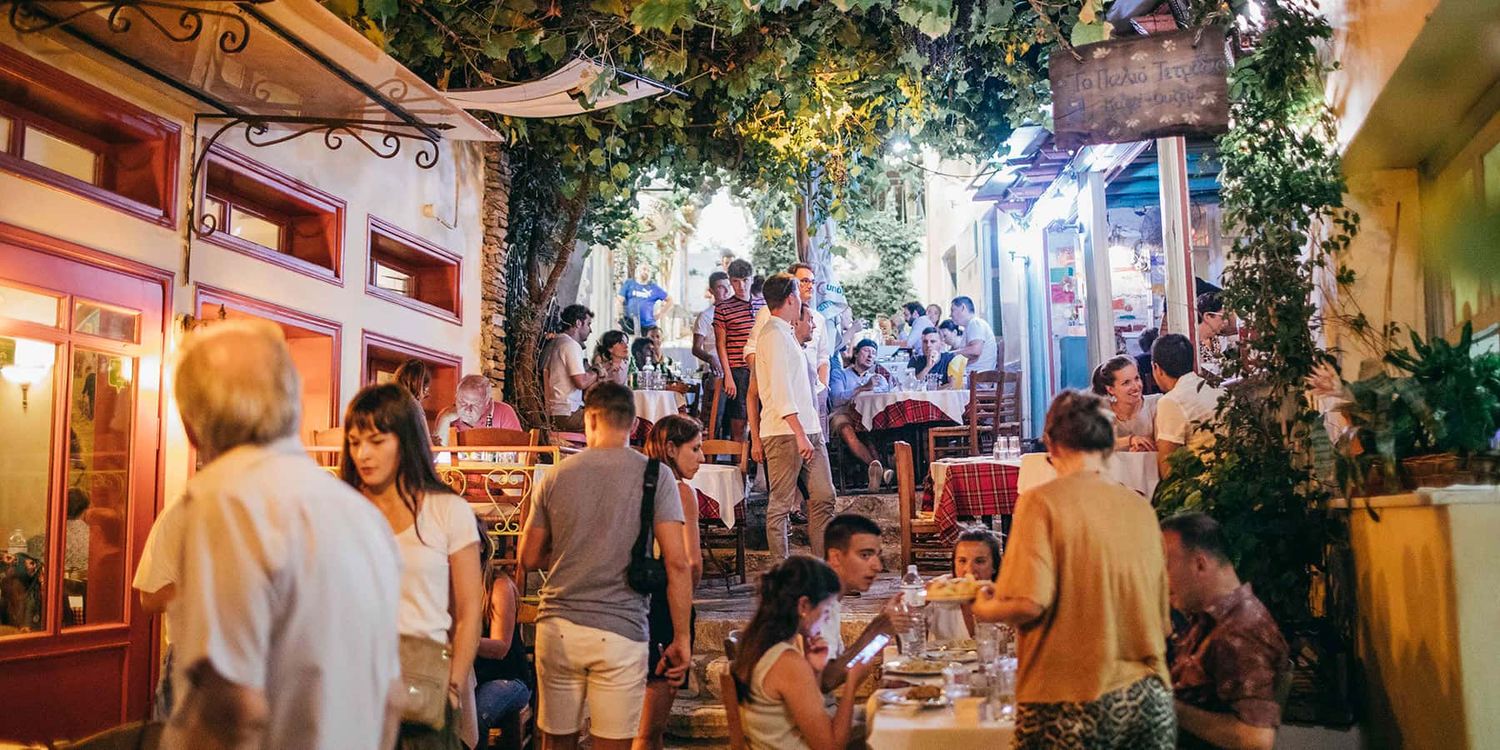 People hanging out at cafe in Athens, Greece at night.