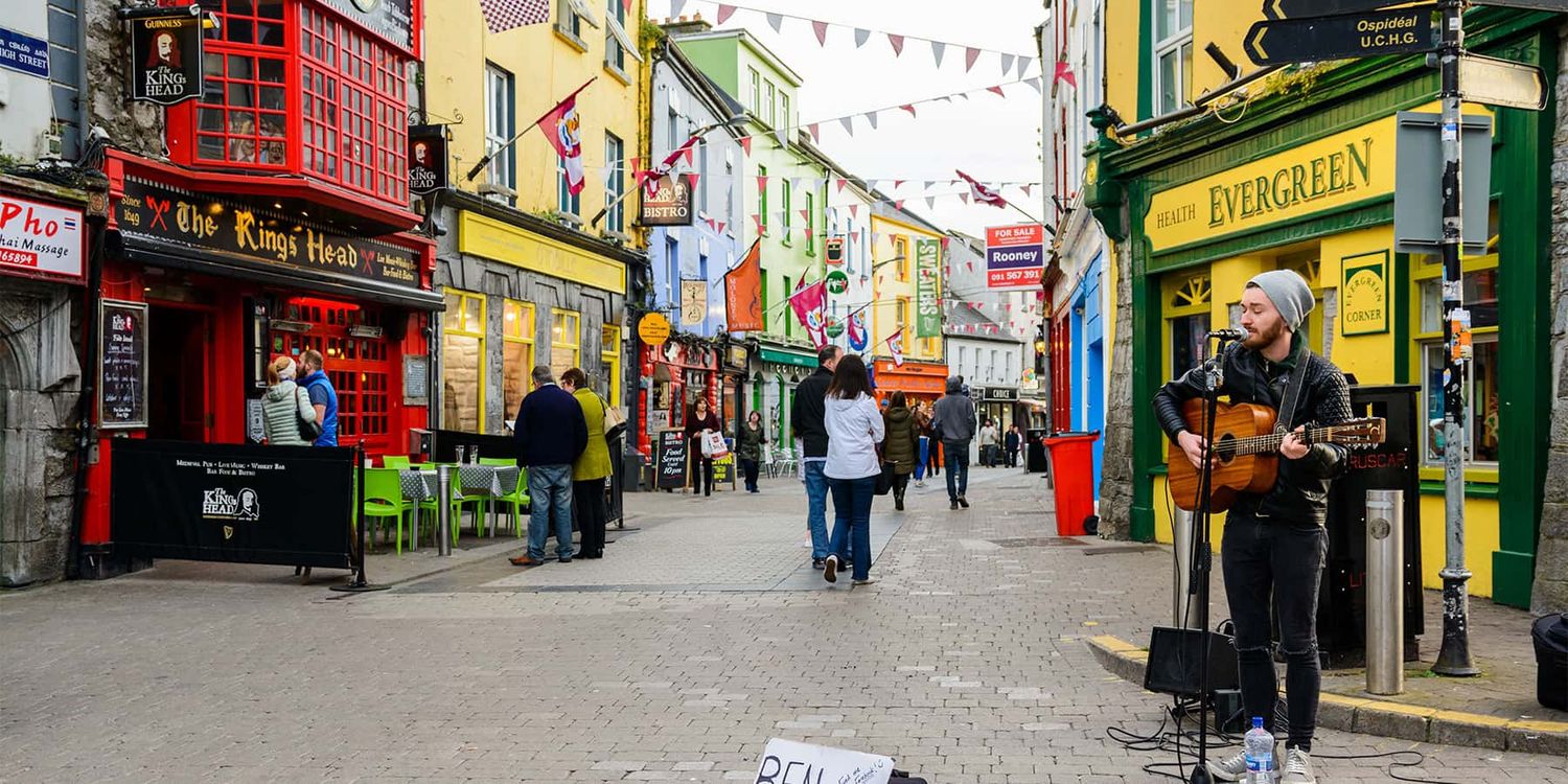 A busker plays his guitar on Quay Street in Galway