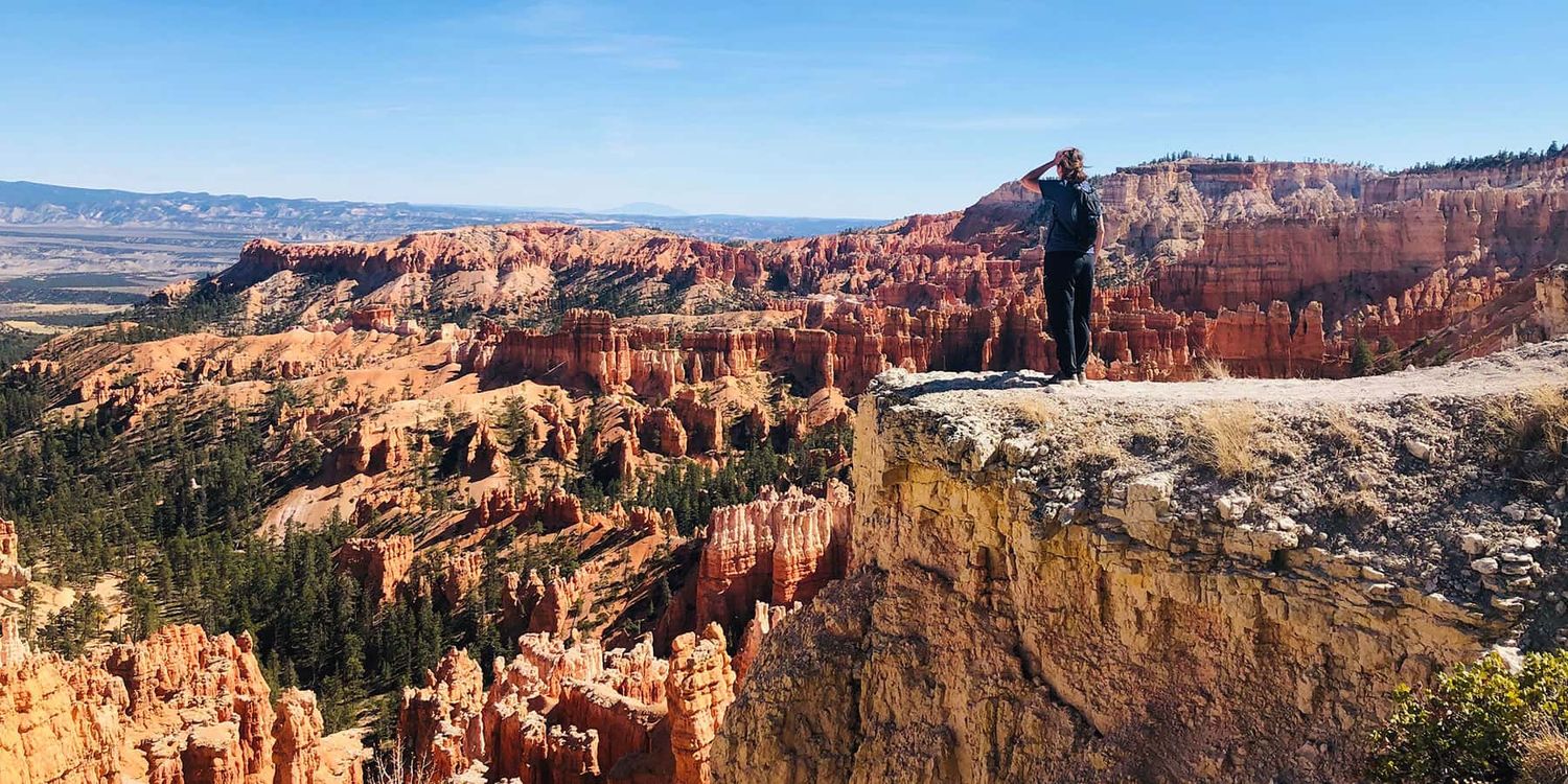 A traveler gazing out over the funky hoodoo spires at Bryce Canyon National Park in Utah.