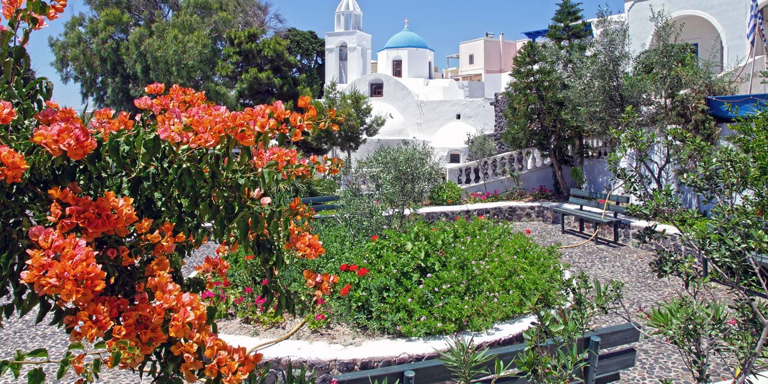 Garden and cobblestone streets in the village of Megalochori, Santorini.