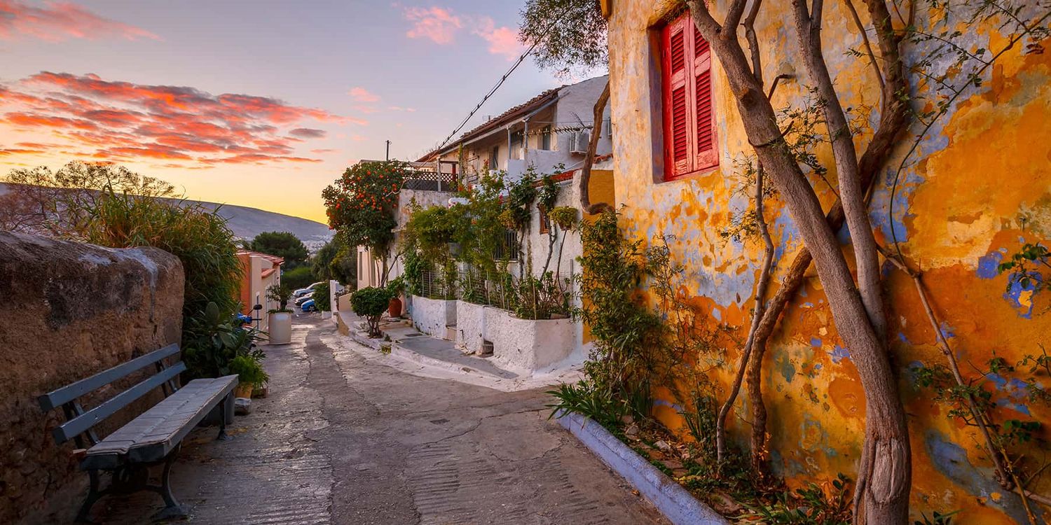 Narrow walkways and staircases of Anatiofika, a quaint colorful village in Athens, Greece.