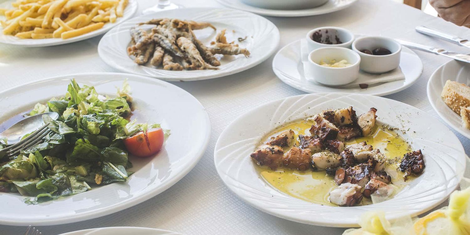 A table setting in of grilled octopus in Athens, Greece.