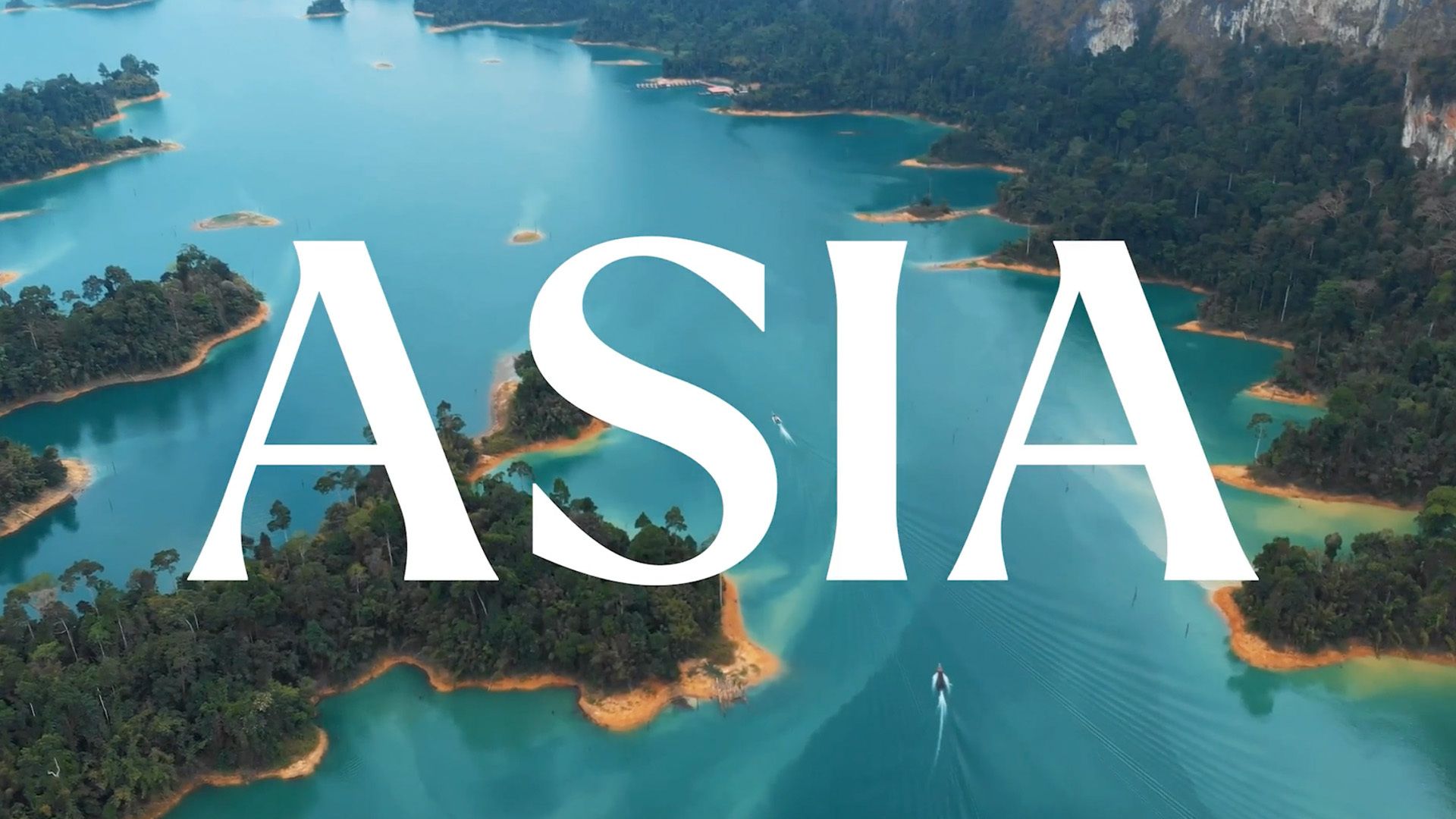 "Asia" text over an aerial shot of a boat cruising down a blue river with trees on either side.