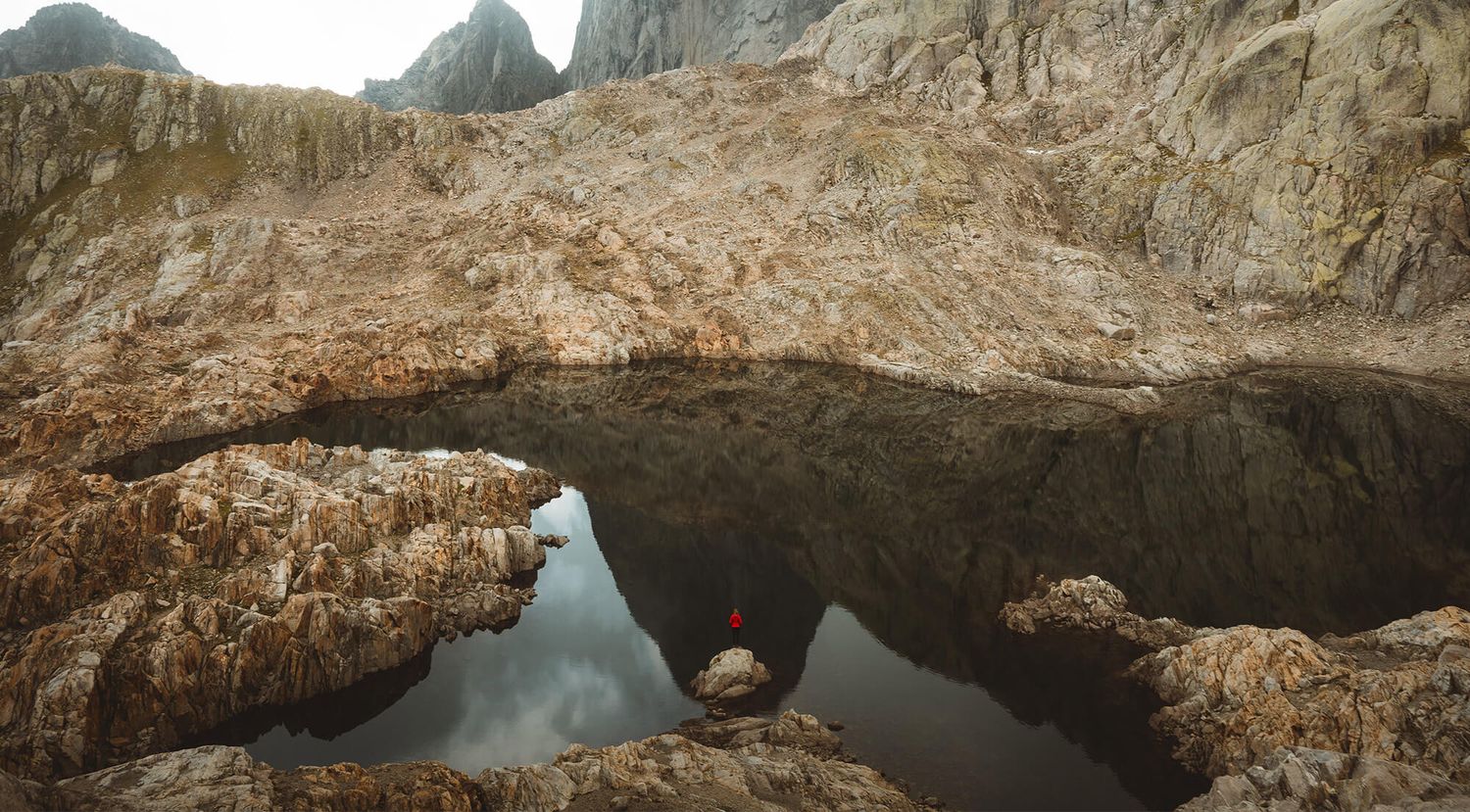 A huge lake surrounded by rocky mountains.