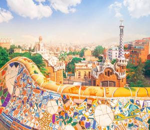 View of a city from a colorfully-tiled balcony