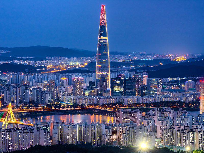 A city, river, and skyscraper at night in South Korea's capital city of Seoul.