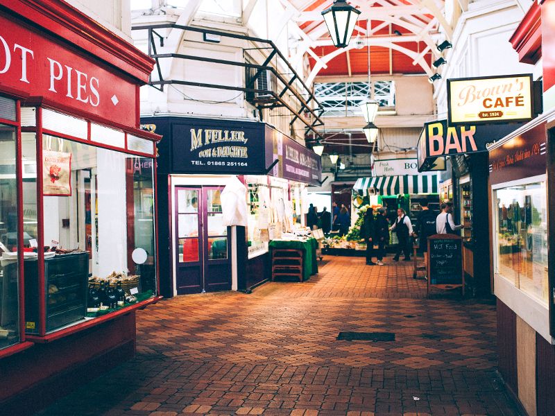 An indoor food market with several cafes and restaurants