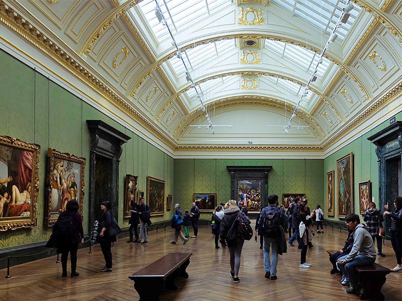 Expansive room at National Gallery with people looking at various art around the room