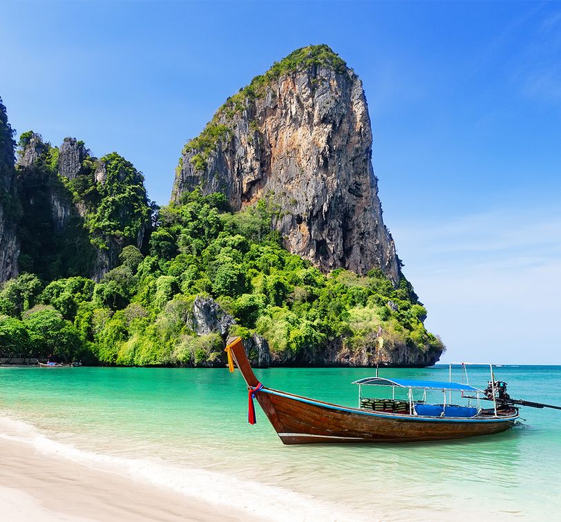 Thai traditional wooden longtail boat and beautiful sand on a beach in Thailand