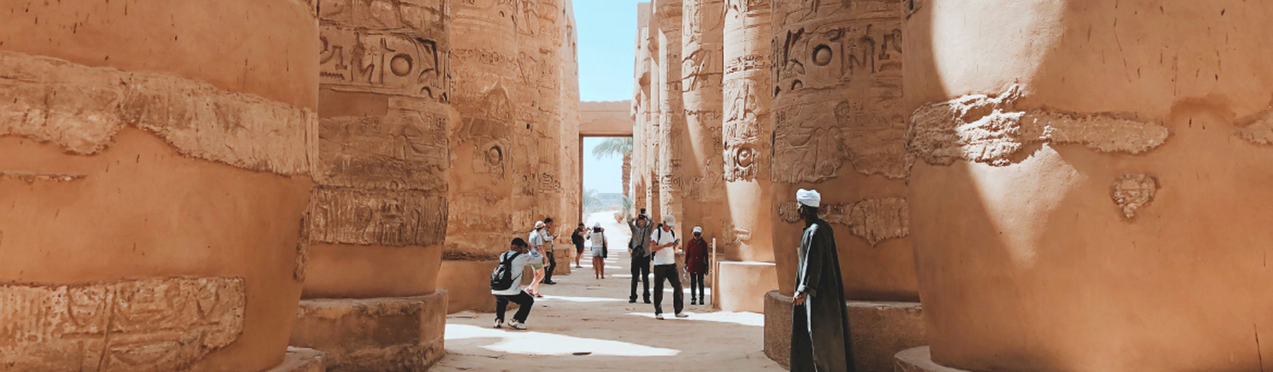 Group tour through Egyptian temple guard in Luxor, Egypt