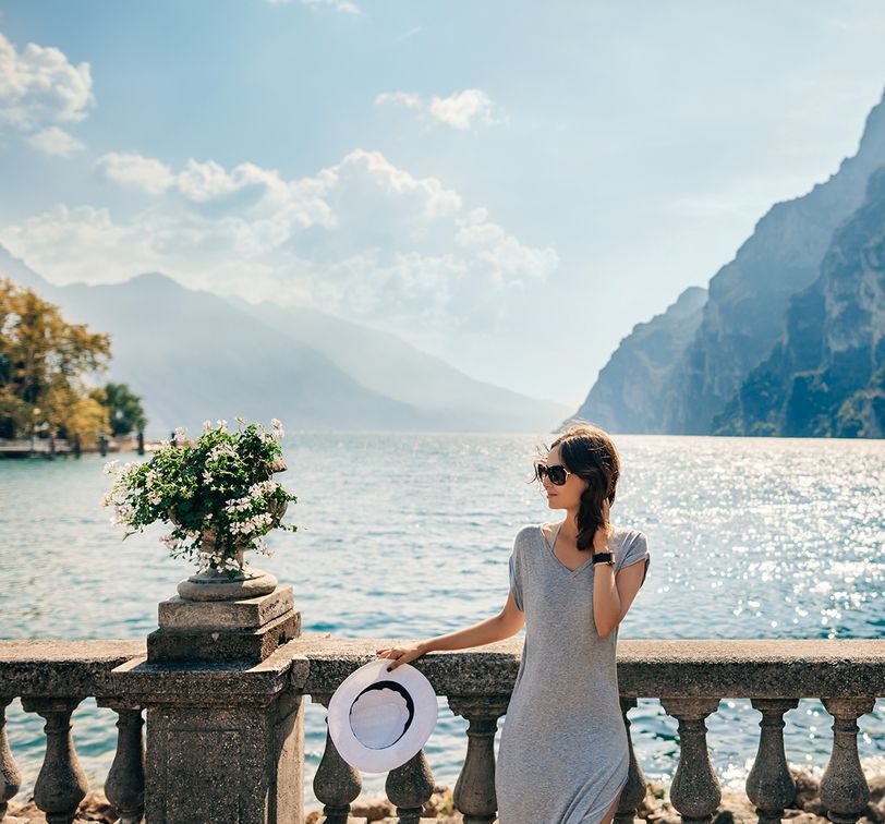 woman standing in front of lake como