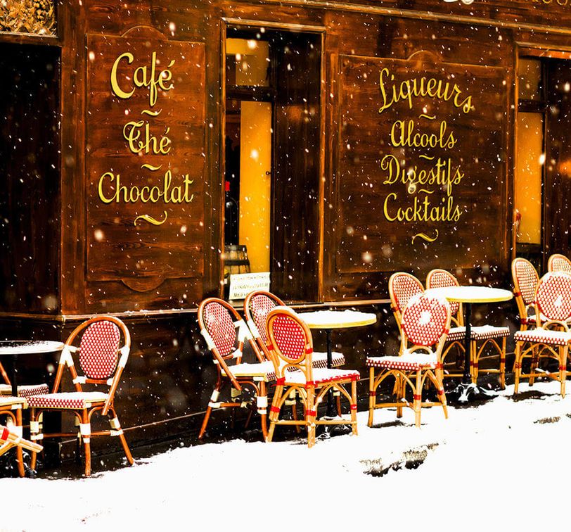 tables and chairs outside of cafe in london covered with snow