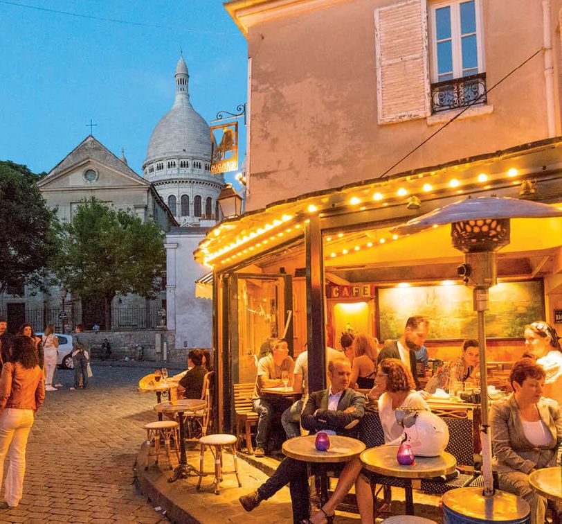people sitting at a cafe in madrid at night