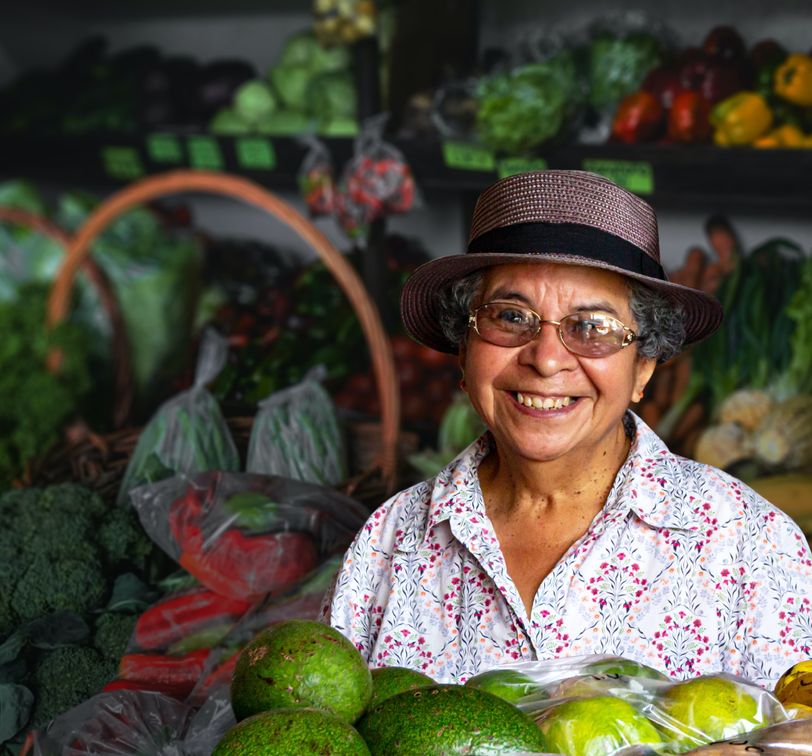 a smiling woman selling vegetables in boquete panama