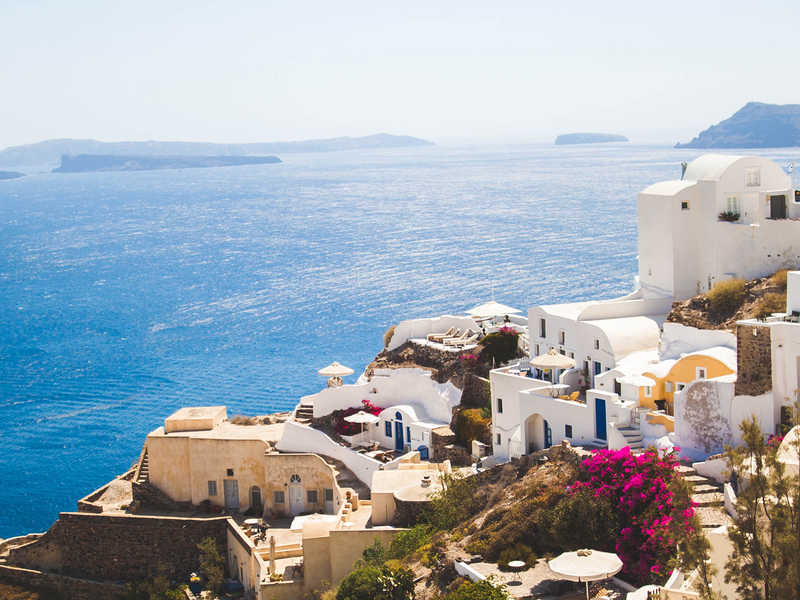 views of the aegean sea from the greek islands with white buildings in the foreground