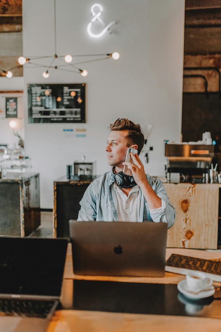 Small business owner running payroll on a laptop at a desk