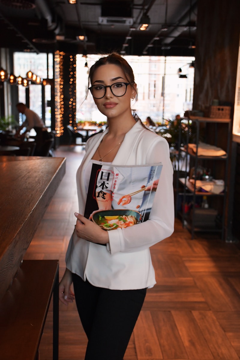 Hospitality worker reviewing a roster on a tablet at a restaurant