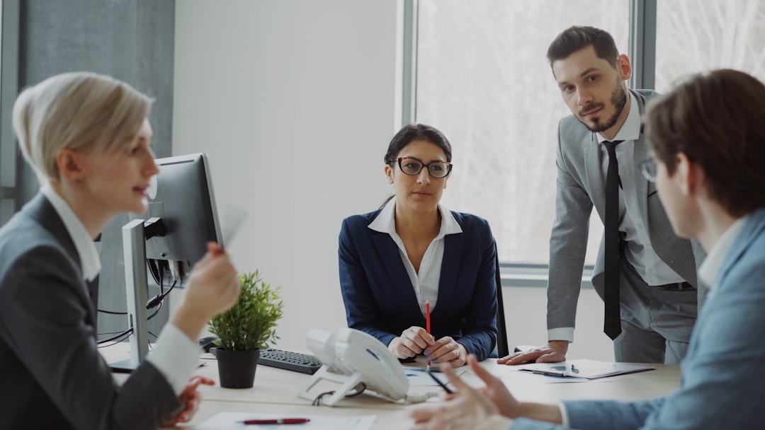 A manager leading a morning team briefing with staff around a table