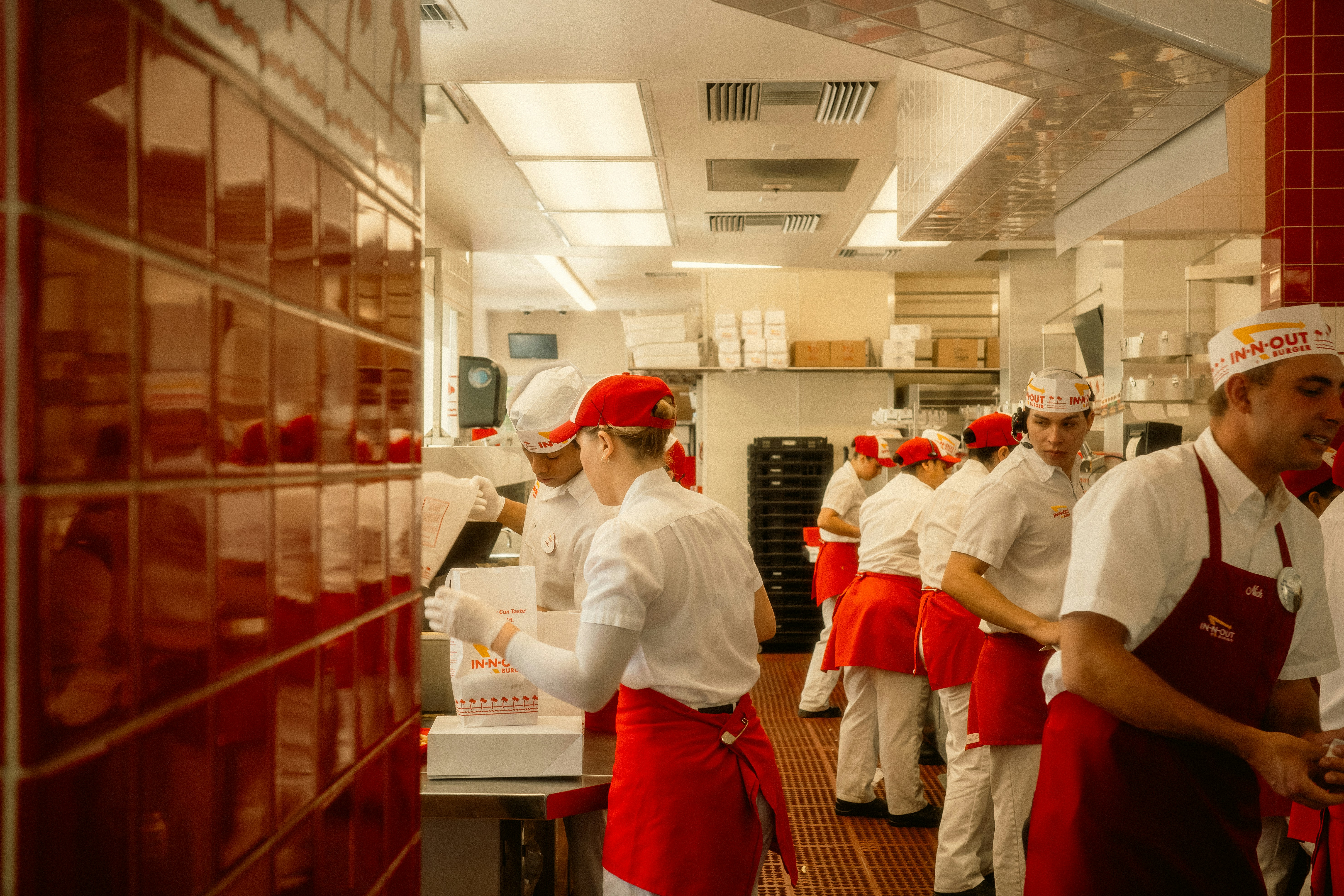 Restaurant kitchen staff working together during a busy service