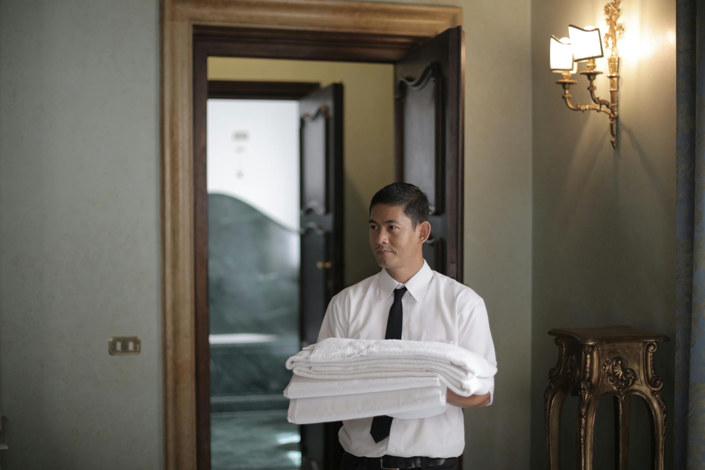 Hotel manager reviewing schedules on a computer at the front desk