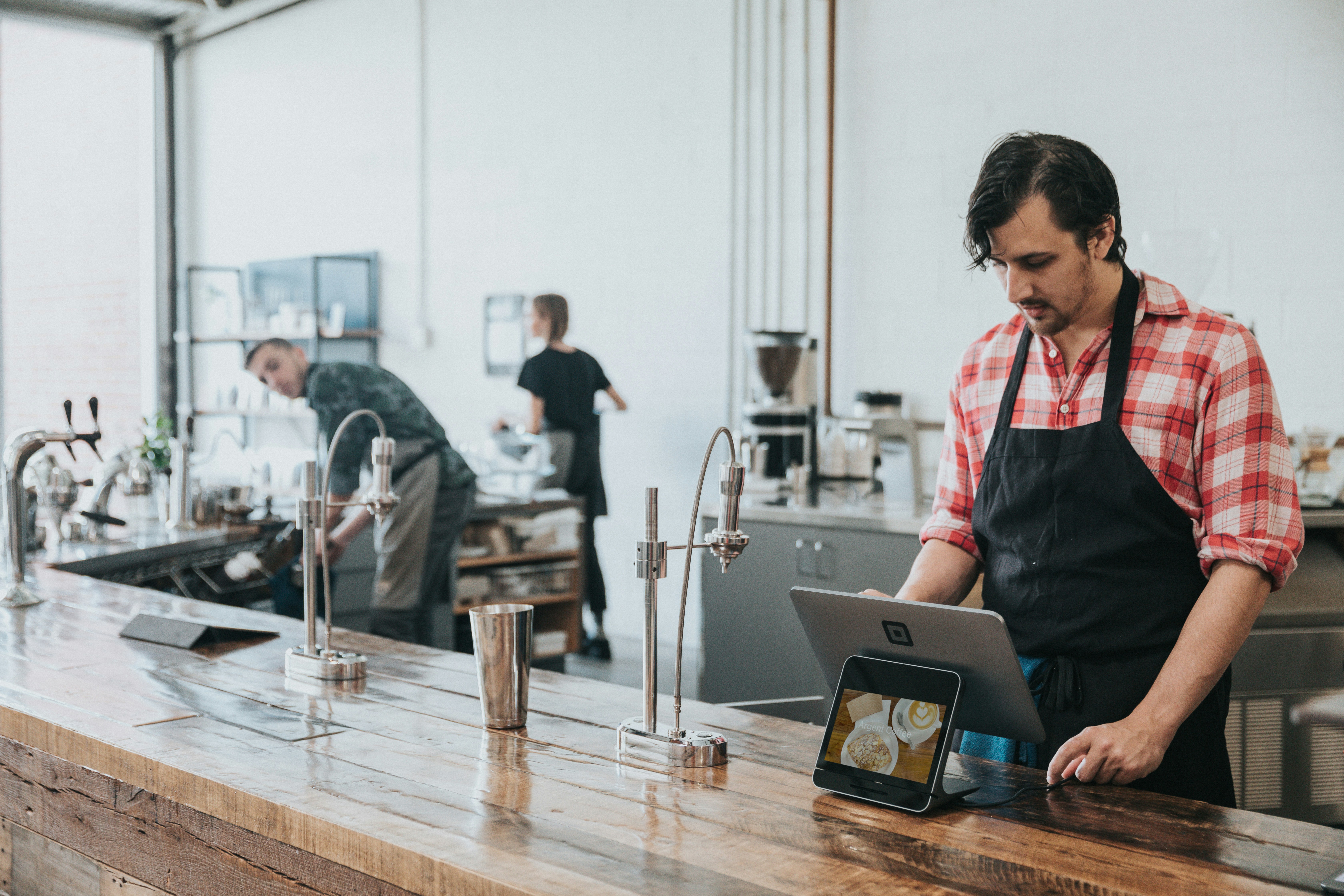 Restaurant staff member reviewing a tablet while working a shift