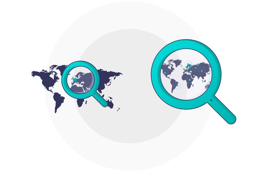 A magnifying glass looking at a world map, searching for the perfect candidate.