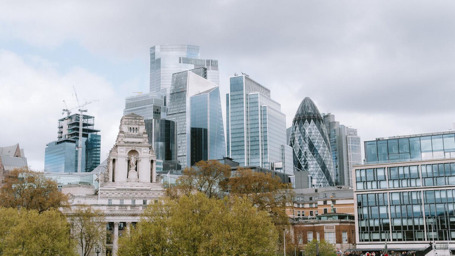 London financial district skyline featuring modern skyscrapers and historic buildings.