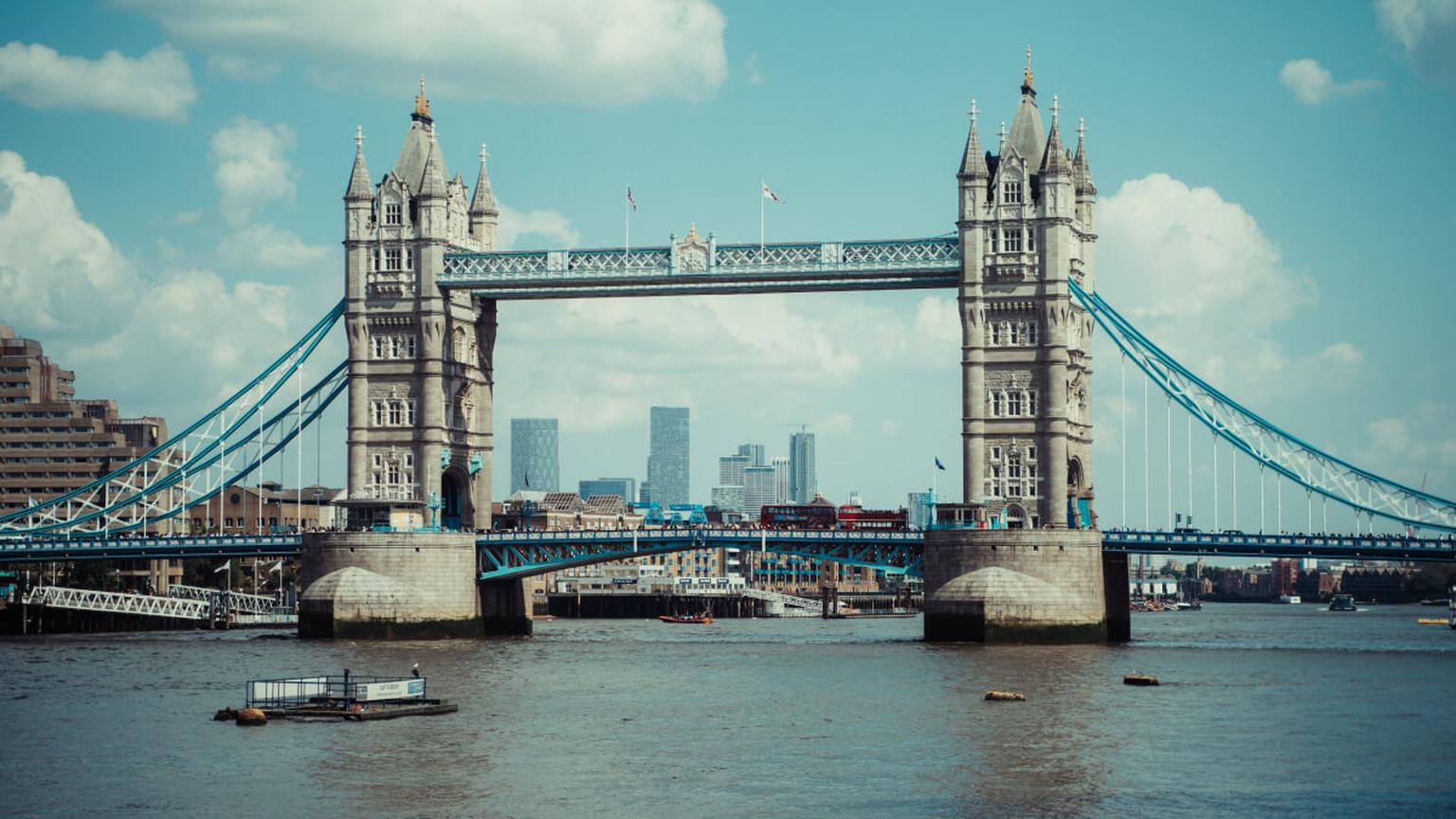 View of Tower Bridge spanning the River Thames with the London skyline in the background.