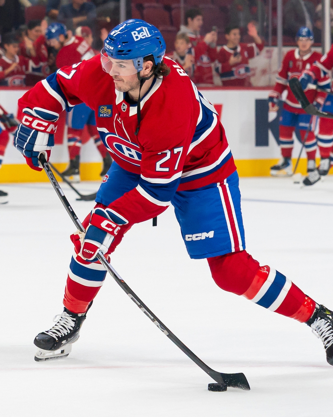 Samuel Blais of the Montreal Canadiens shoots the puck in a red home jersey at the Bell Centre.