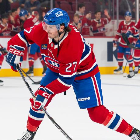 Samuel Blais of the Montreal Canadiens shoots the puck in a red home jersey at the Bell Centre.