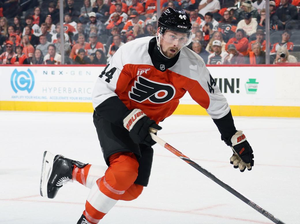Simon Benoit in a orange and white Flyers jerseys skating
