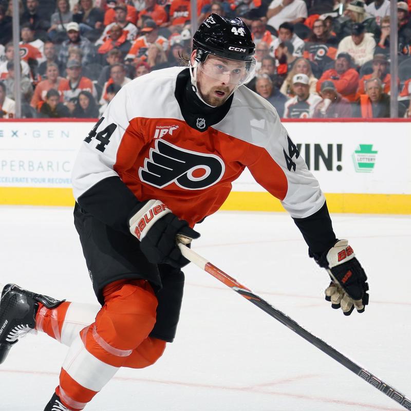 Simon Benoit in a orange and white Flyers jerseys skating