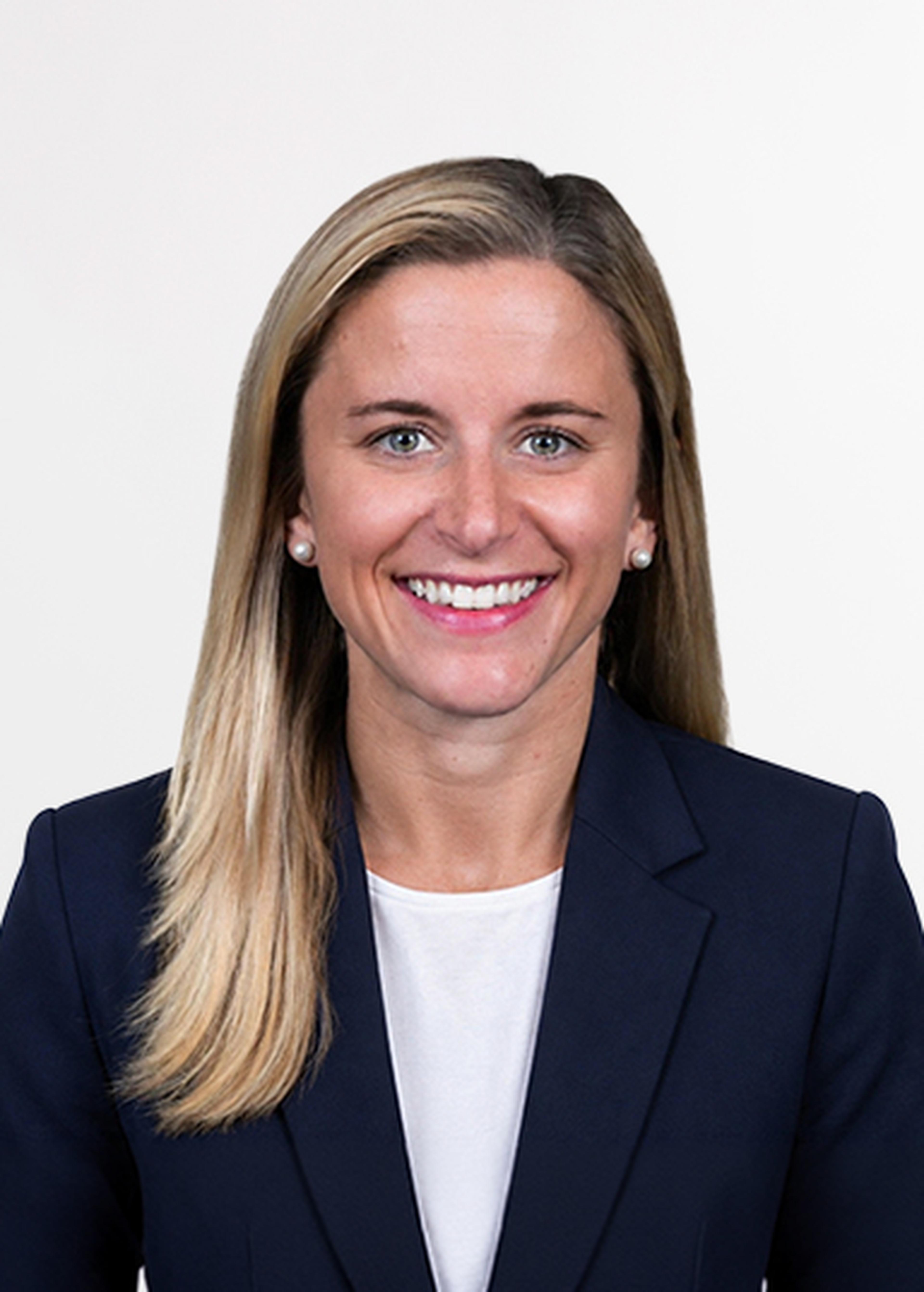 Headshot of Whitney Colbert wearing a dark blue blazer with a white t-shirt.