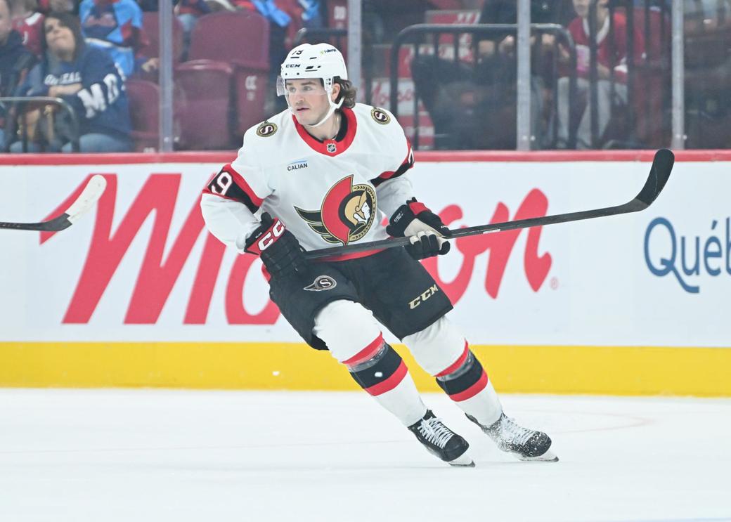 Samuel Blais in a white, red, and black Senators uniform turning on the ice.
