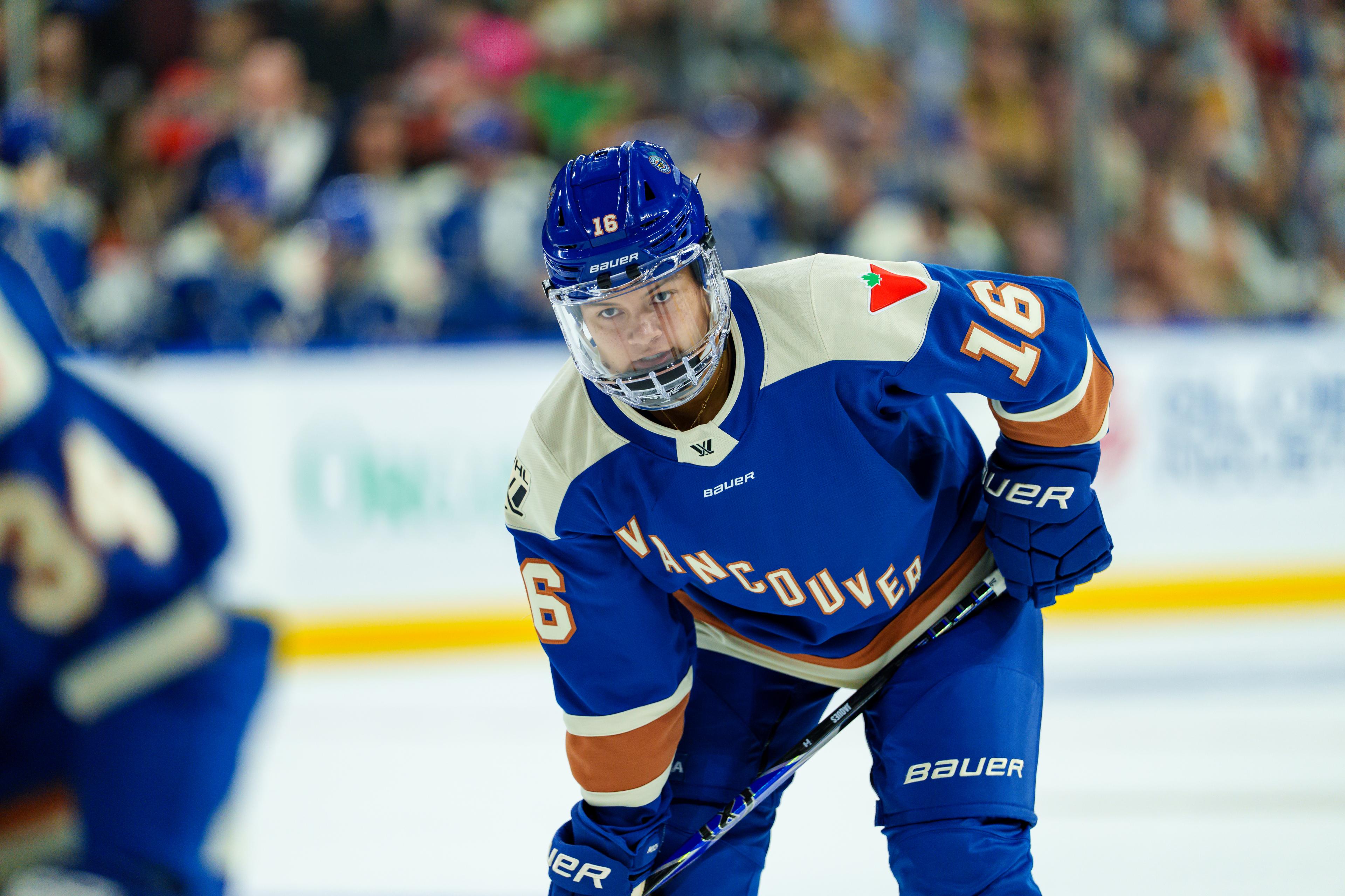 Sophie Jaques in blue Goldeneyes jersey, focused and ready for the face-off.