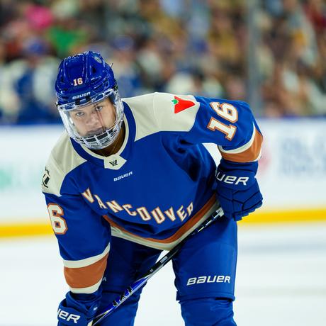 Sophie Jaques in blue Goldeneyes jersey, focused and ready for the face-off.