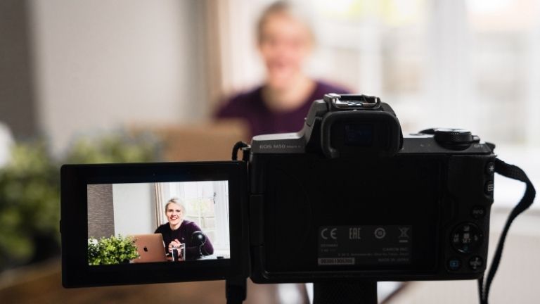 DSLR camera facing a person