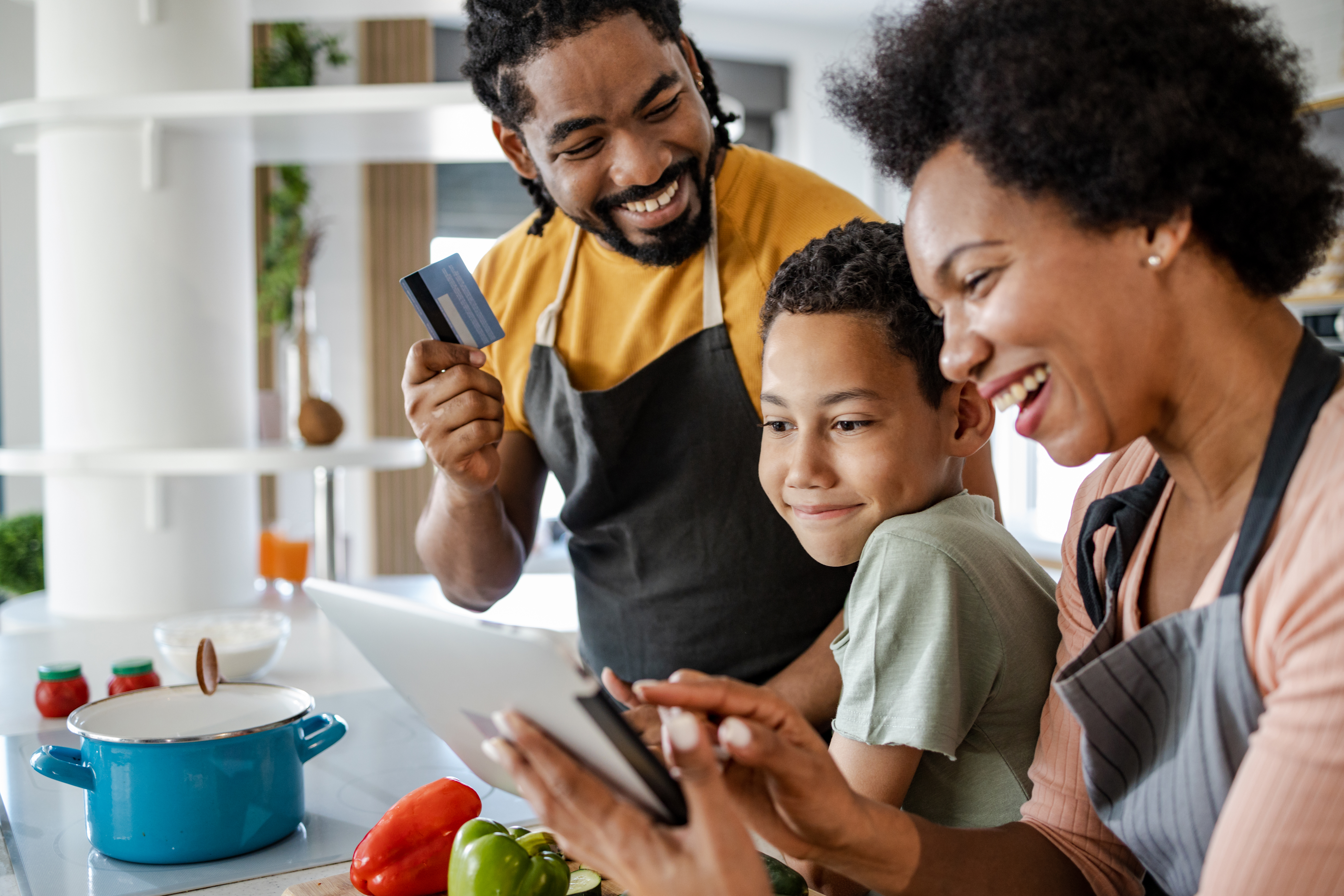 Family preparing dinner and ordering groceries online
