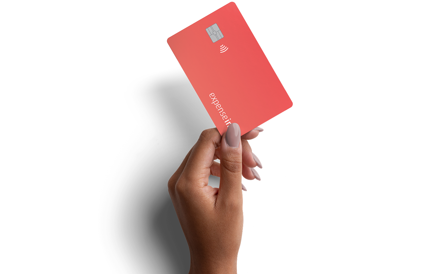 A hand with manicured nails holds a coral-colored credit card displaying a chip and contactless symbol.